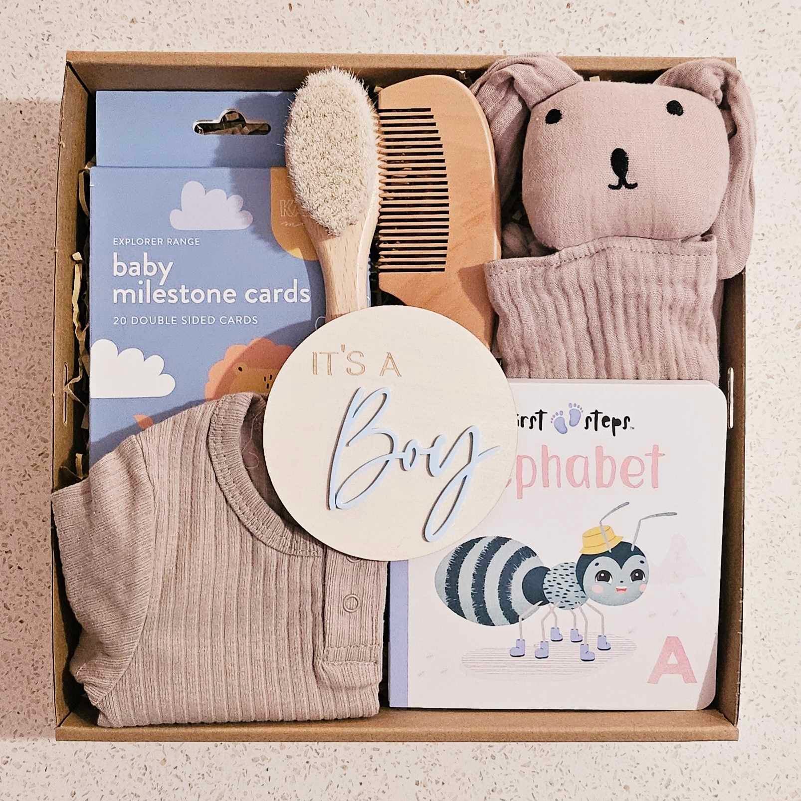 Little Prince Baby Box featuring milestone cards, baby book, brush and comb set, playsuit, wooden photo prop, and rabbit comforter, beautifully topped with confetti and a bow, perfect for newborn baby boy gifts in Perth, WA.