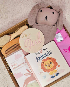 Image of The Little Princess Gift Box: The Little Princess Gift Box with milestone cards, baby book, comb, brush, comforter, playsuit, and wooden photo prop, elegantly presented with a satin bow.