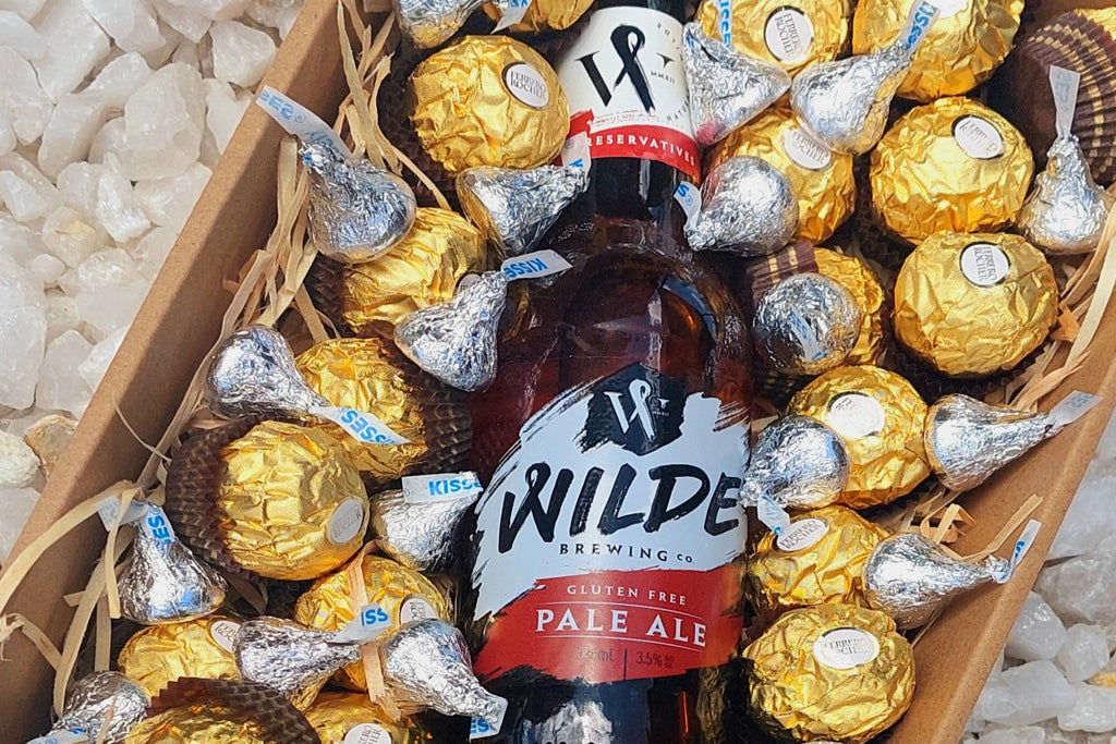 A fun Beer and Chocolate gift box featuring a refreshing pale ale paired with indulgent Ferrero Rocher chocolates, elegantly arranged for a delightful treat perfect for beer and chocolate lovers.