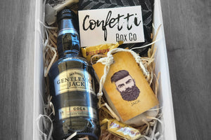 Elevate your relaxation game with our Gentleman's Essentials Box. Featuring a Gentleman Jack's Stubby, cotton business work crew socks (size 6-11), and three mini Toblerone chocolates, it's a blend of sophistication and comfort. Complete the experience with Legendary Aussie's Jack Beard Oil, infused with eucalyptus and lavender for a strong, natural scent. Perfect for the modern gentleman seeking indulgence and refinement.