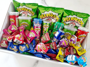 Ultimate Sour Sensation Gift Box: A thrilling collection of Warheads sour treats, including Warhead Sour Sprays, Warhead Candy, Sour Bombs, Double Drops, Mega Warheads, Gum Pops, and Minis. Perfect for sour candy lovers, all topped with additional lollies or chocolates for an extra burst of flavor.