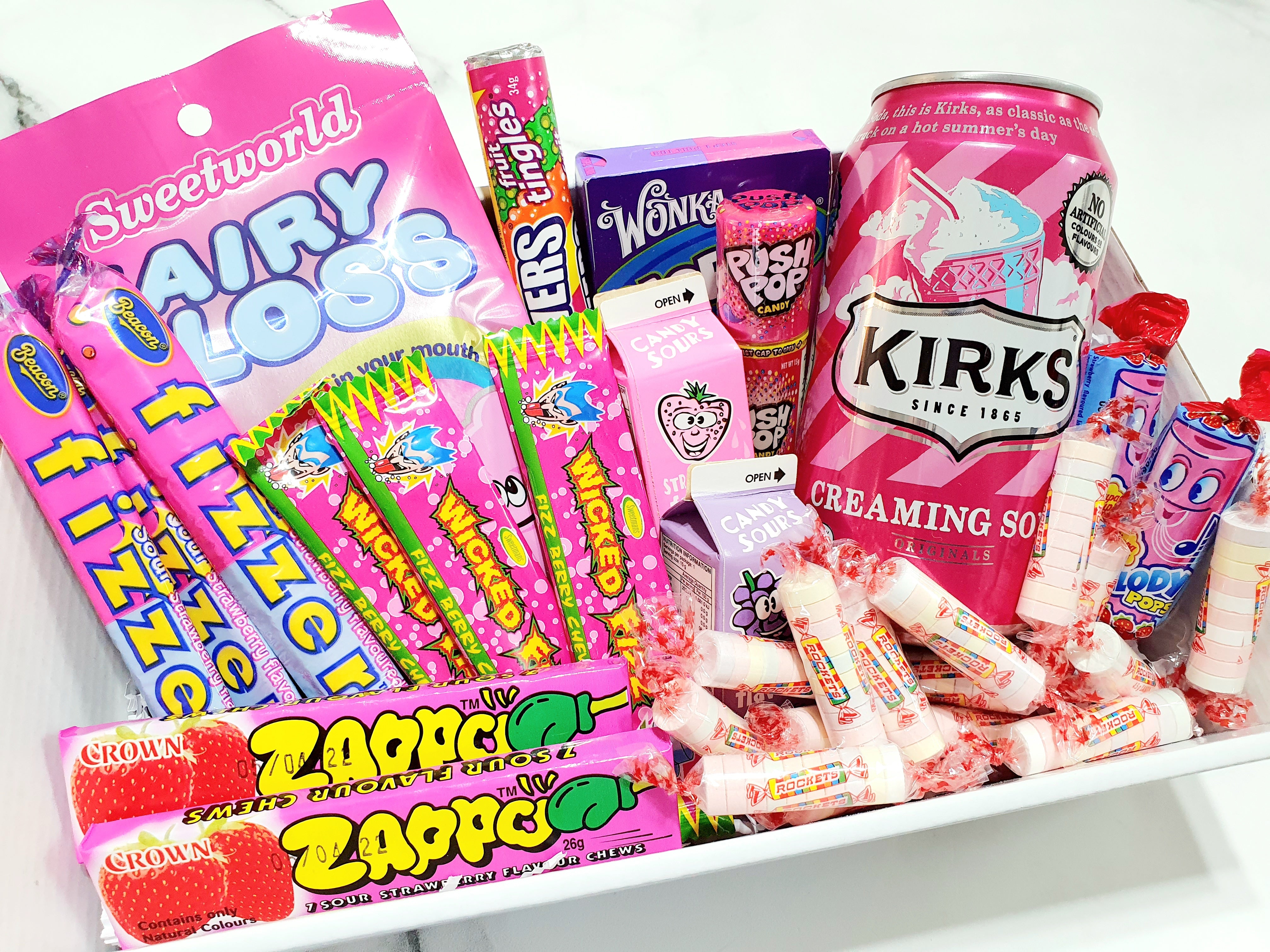 Pink Themed Gift Box: The perfect present for someone who loves all things pink! Includes Kirks Creaming Soda, Push Pop, Nerds, Fairy Floss, Wizz Fizz, Fizzer Sticks, Zappo, Rockets, lollipops, and Candy Sours. A sweet and colorful treat for any occasion.