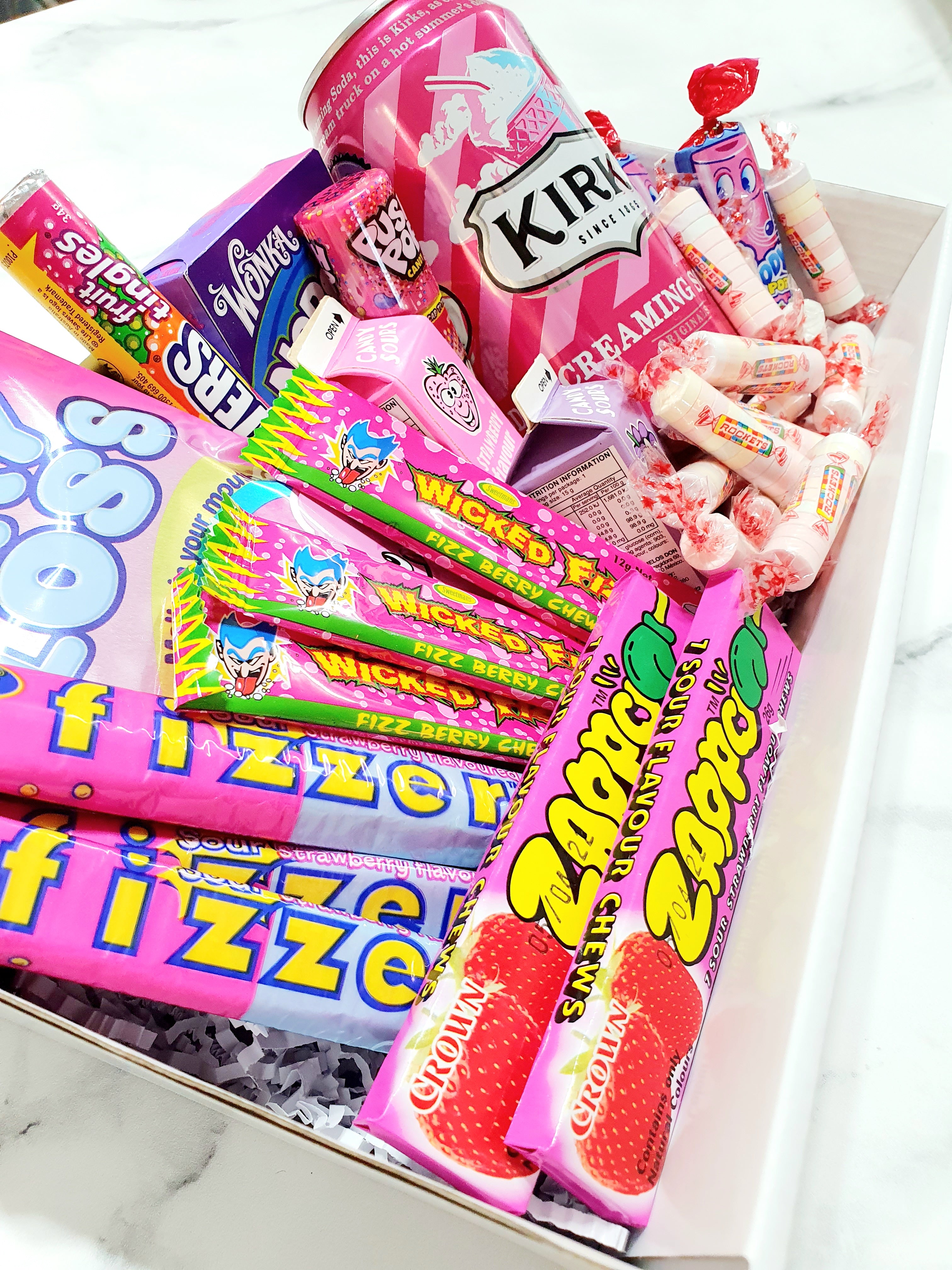 Pink Themed Gift Box: The perfect present for someone who loves all things pink! Includes Kirks Creaming Soda, Push Pop, Nerds, Fairy Floss, Wizz Fizz, Fizzer Sticks, Zappo, Rockets, lollipops, and Candy Sours. A sweet and colorful treat for any occasion.