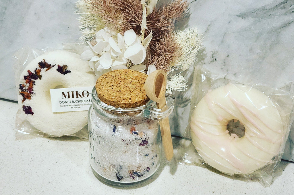 Relaxation Gift Pack: Unwind with preserved and dried flowers, a luxurious Miko Cosmetics handmade bath bomb, donut-shaped soap, and a soothing bath soak featuring Lavender and Rose blend with Epsom salt, rose petals, lavender oil, and Himalayan salts. Perfect for a serene and rejuvenating experience.